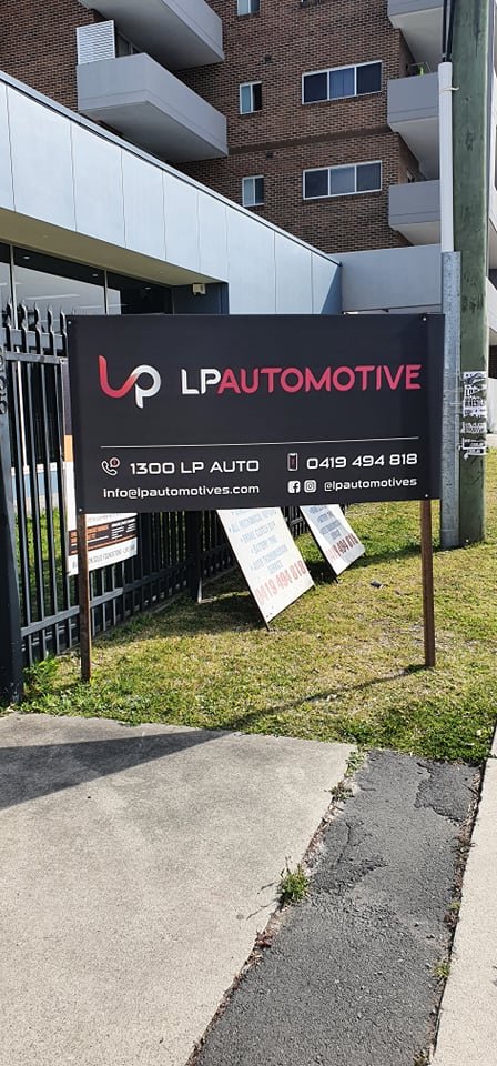 The LP Automotive sign on the grass verge outside the Gilba Rd premises, reading 1300 LP AUTO